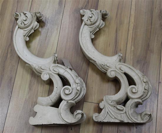 A pair of carved wood brackets